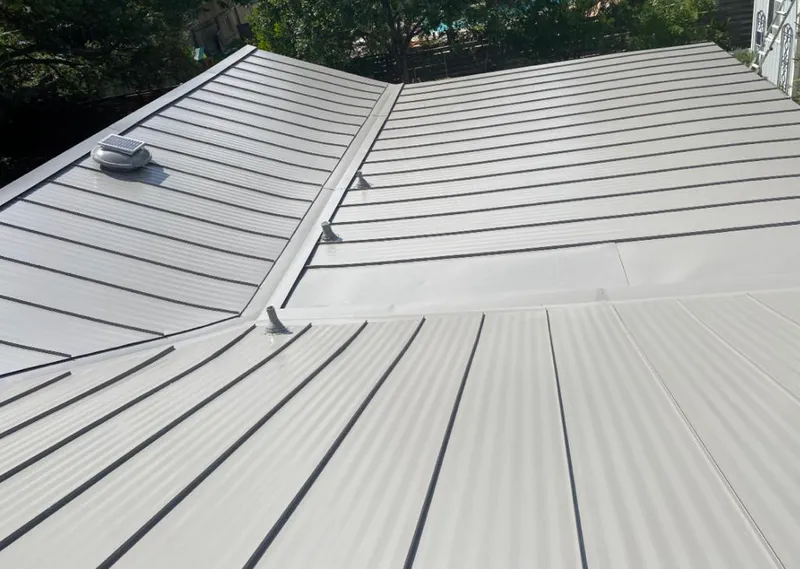 Solar attic fan installed on a metal roof for Roof Ventilation in Nyack