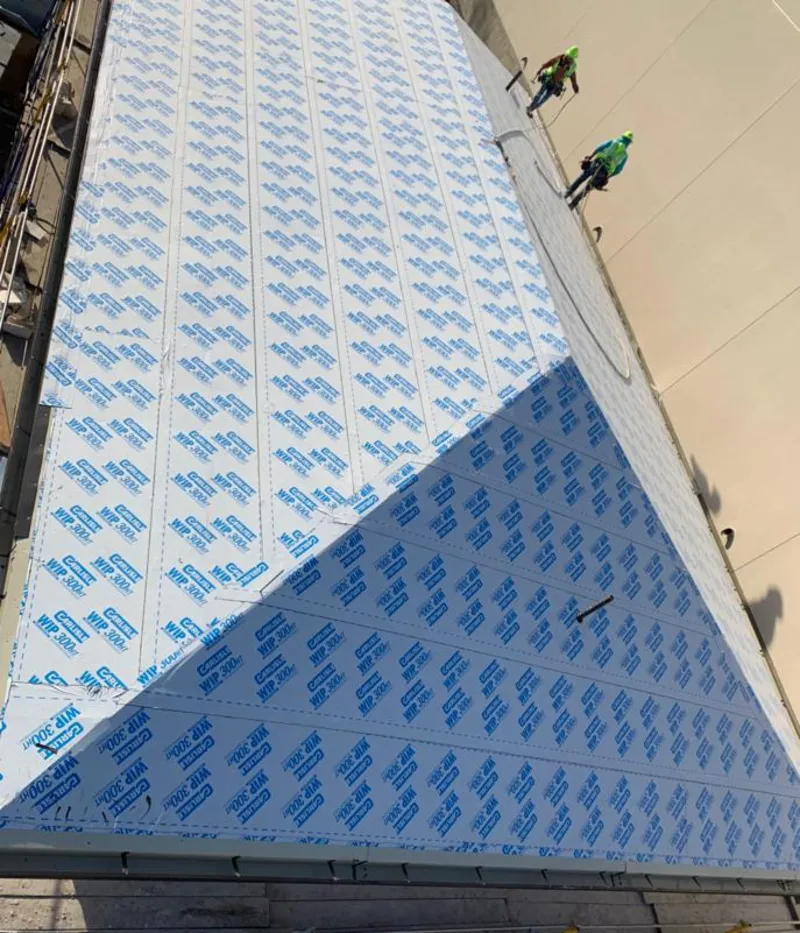 Professional roofers installing underlayment on a metal roof in Nyack